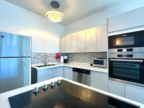 The apartment features a full kitchen equipped with everything you need, including modern appliances, cookware, and utensils—perfect for preparing meals during your stay.