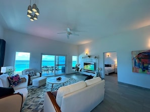 Sea Heaven features an open-concept living space that seamlessly combines the living room, dining area, and kitchen, creating a spacious and airy environment perfect for both relaxation and entertaining, with beautiful views of the ocean.