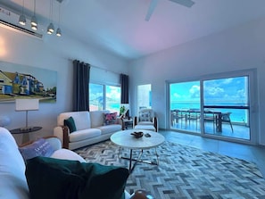 The living area offers stunning ocean views, with large windows that bring the beauty of the sea indoors, creating a bright and inviting space to relax and enjoy the serene surroundings.