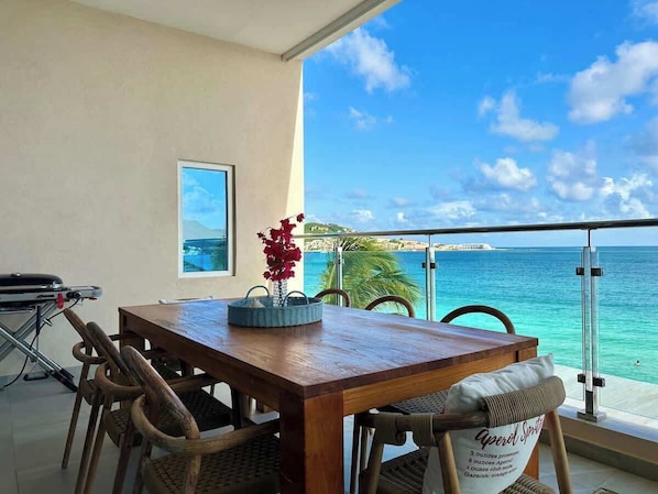 The balcony features a spacious dining area for eight, perfect for enjoying al fresco meals while taking in the breathtaking views of the ocean and surrounding scenery.