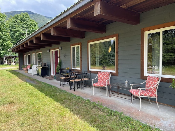 Your vacay home with covered porch, seating and dining areas