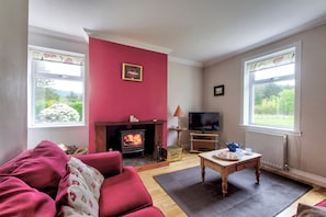 The snug has double aspect views over the garden and beyond and a log burner for those winter evenings