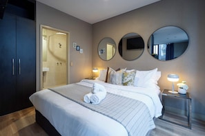 King size bed with a TV on the wall