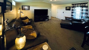 Livingroom with large Roku flatscreen.