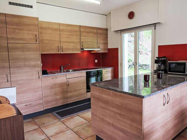 Kitchen, Countertop, Kitchen Appliance, Flooring, Furniture, Cabinetry, Major Appliance, Floor, Wood, Interior Design