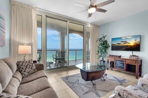 Living room with balcony access and flat-screen TV