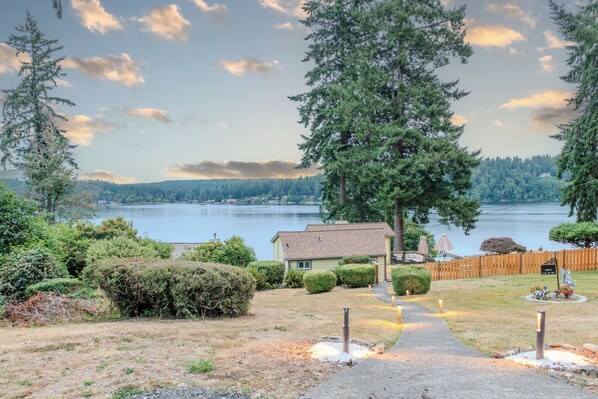 Your home away from home is the yellow cottage after a meandering walkway