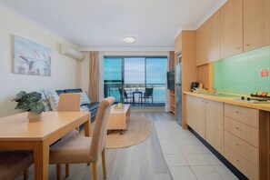 The studio's open design blends cooking, dining and lounging areas seamlessly, all cooled by a split-system air conditioner.