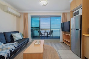 Start your stay in the inviting lounge, where glass doors open onto a private balcony overlooking the lakefront – a perfect spot to unwind after an active day.