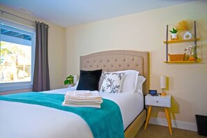 Cozy and comfortable bedroom with a plush queen-sized bed, fresh linens, and plenty of natural light. Includes a closet, bedside tables, charging stations and can’t forget the 65” TV to make you feel right at home. (2)