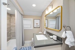 Full bathroom with tub and shower