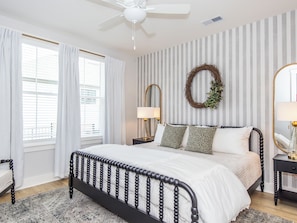 Cozy king suite with striped accent wall & designer decor
