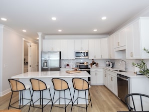 Spacious gourmet kitchen with island seating for 5 and ample storage