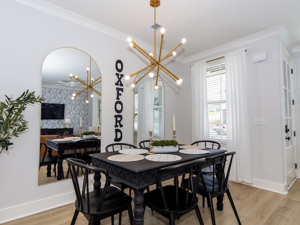 Stylish dining space with seating for 6 and bold modern lighting