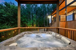 Soak under the stars with pine trees all around.