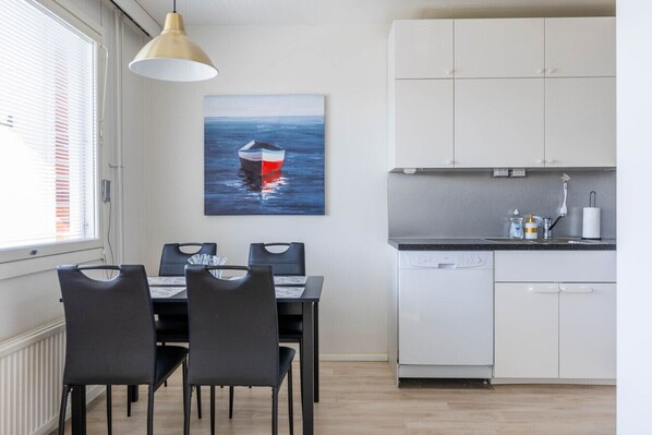 Dining room for four, adjacent to the open kitchen.