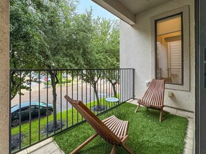 Cozy balcony with a beautiful view— perfect for enjoying a morning coffee.