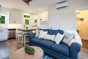 Relax in the stylish living space with plush seating and direct access to the outdoors—perfect for family gatherings.