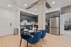 Dine in comfort at a chic four-person dining area just steps from the kitchen.