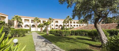 Stroll peaceful stone pathways surrounded by greenery—just a 4-minute walk to the beach.