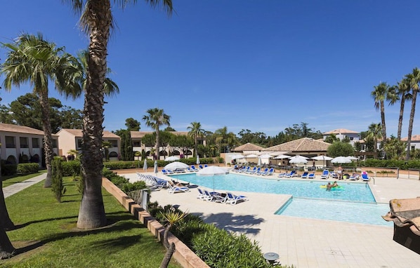 Sunbathe or unwind by the spacious main pool, perfectly placed for summer days in Linguizzetta.