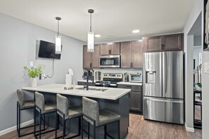 Fully equipped kitchen with modern appliances and a TV for added entertainment while you cook.
