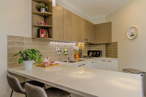 Fully equiped kitchen. Microwave oven, range hood, induction cooker, dishwasher