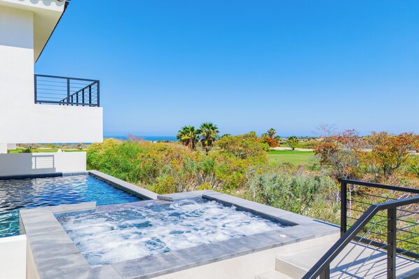 Jacuzzi and pool with ocean views