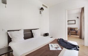 Comfortable double bed in the private bedroom, offering a quiet retreat within the city-style apartment.