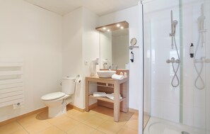 Modern bathroom with walk-in shower, sleek vanity, and thoughtful touches for a comfortable stay.