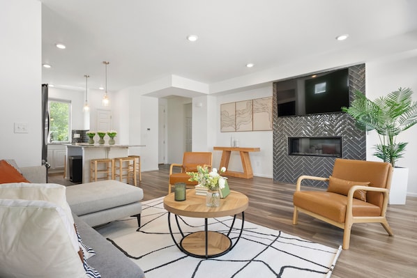 Cozy living room, fireplace, modern kitchen, natural light, perfect stay.