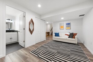 Bright lounge with comfy sofa, modern decor, perfect for work or relaxation.
