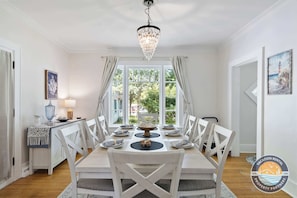 Sunny dining room with classic charm and big windows.