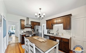 Open kitchen with dining table, island, and modern touches.