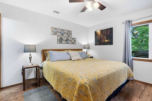 The primary suite features a king-sized bed, ensuite bath, & TV
