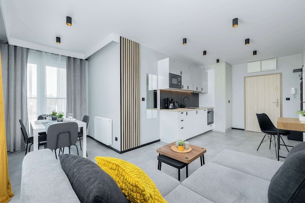 The spacious living room impresses with its modern decor, bright walls and comfortable upholstered sofa, creating the perfect place to relax after a busy day.
