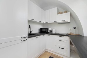The fully equipped kitchenette includes everything you need for a home-cooked meal.