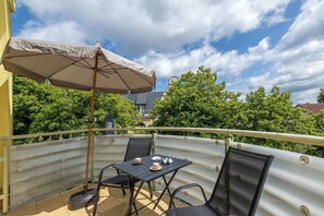 The balcony's stylish design complements the apartment's decor.