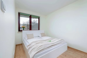 Bedroom with a double bed and a bright interior.