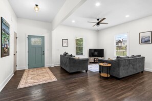 Step into the home and be greeted by a cozy rug that leads you into the warm and welcoming living area — perfect for relaxing after a day of exploring.