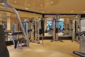Fitness room with weight machines and mirrored wall surround