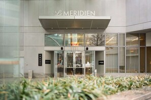 Main entrance to Le Méridien with glass doors and sleek canopy