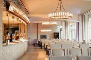 Elegant dining room with chandeliers and open kitchen counter