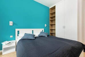 Another angle of the twin bedroom showing the beds and a wardrobe. Ideal for friends or children.