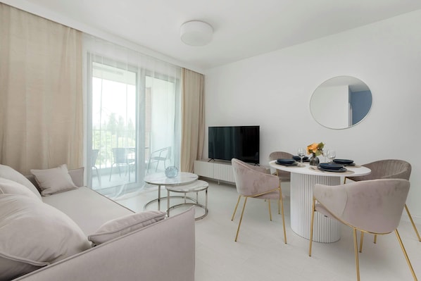 A bright living room with a large window and modern decor creates a space full of light and style.