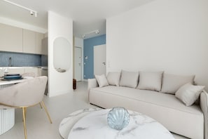 A spacious living room with a corner sofa and coffee table invites you to spend time together.