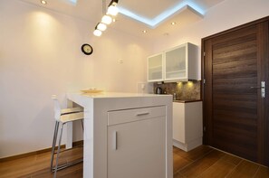 A dining table with two chairs provides a comfortable place when eating meals.