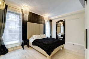 Comfortable bedroom with premium black bedding and sophisticated white decor, offering a peaceful retreat.