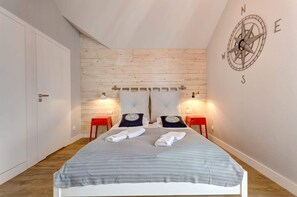Another angle of the studio, showcasing the stylish decor, wooden accents, and a comfortable seating area.