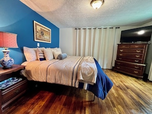 Master bedroom King bed and TV and luxury linens and fluffy blankets